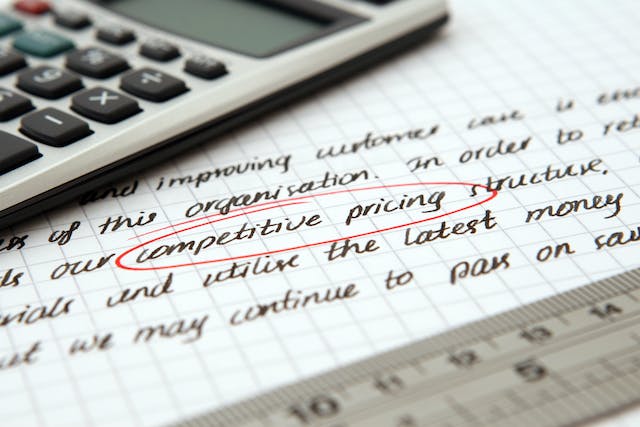 Writing on a graph paper, where the words “competitive pricing” are circled in red.