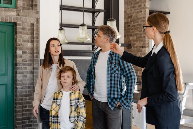 A realtor showing a home to a family.