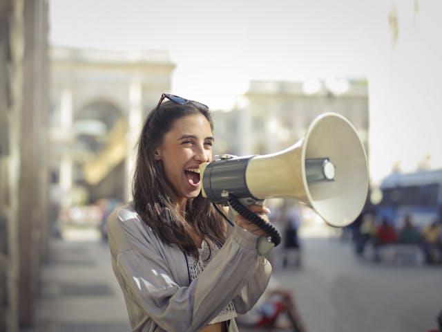 A person yelling into a megaphone.