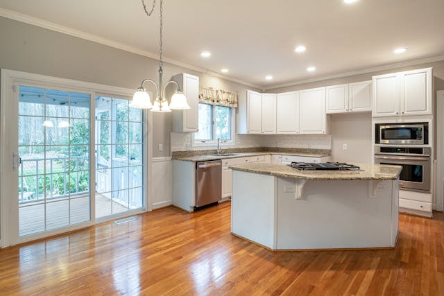 interior of a white kitchen with hardwood floors